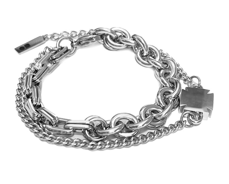 Silver-tone multi-strand chain bracelet mixing rolo, oval, and curb links with a suspended cross charm on a white background.