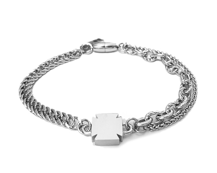 Silver-tone bracelet with a dense woven chain, twin fine strands, and a central cross-engraved square block with lobster clasp.