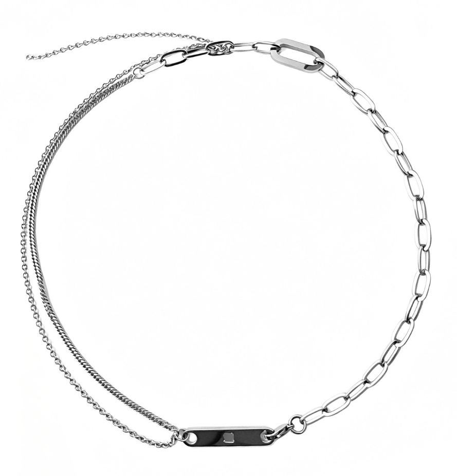 Asymmetric silver-tone necklace with oversized paperclip links on one side, doubled fine chains on the other, and an engraved bar connector.
