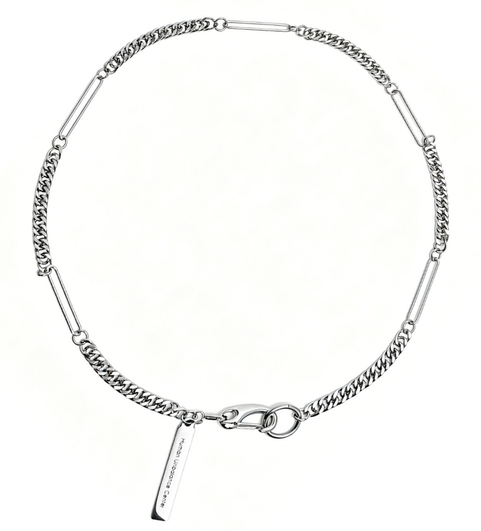 Silver-tone necklace alternating polished curb chain with elongated bar links, a hook clasp, and an engraved hanging tag.