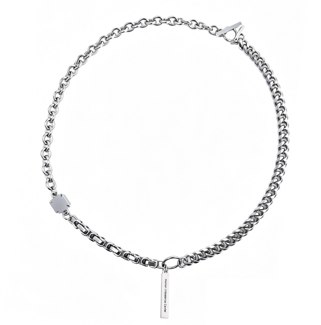 Silver-tone mixed-chain necklace with a cube connector, toggle-bar clasp, and a suspended engraved bar pendant.