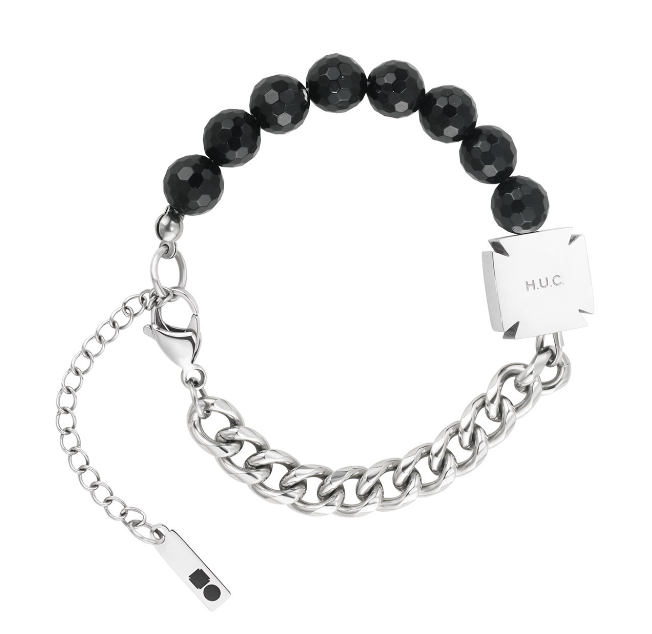 Bracelet with faceted black beads, a silver curb chain, and an engraved square plate.