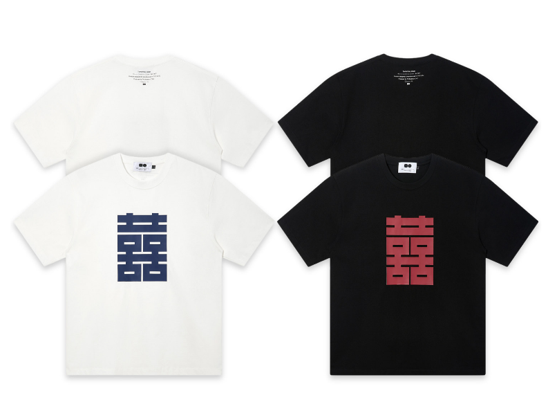 White and black relaxed-fit tees with a large geometric double happiness character printed at center front, navy on white and deep red on black.